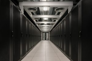 Modern data center aisle with server racks and cooling infrastructure, illustrating energy efficiency and sustainable operations in Canada