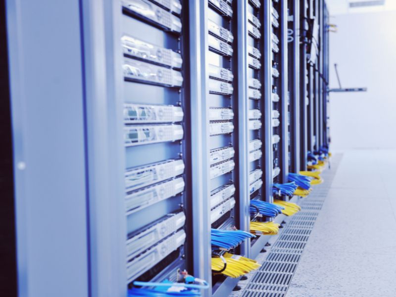 Modern data center aisle with server racks and cooling infrastructure, illustrating energy efficiency and sustainable operations in Canada
